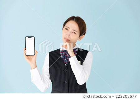 Woman in uniform, smartphone, worries 122205677