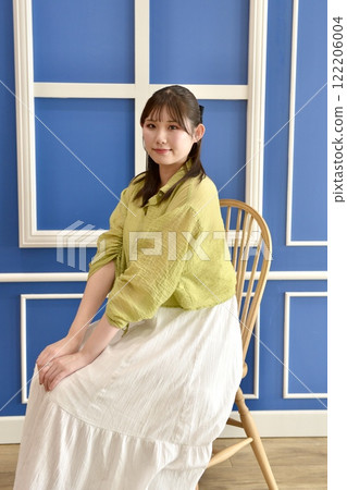 Portrait of a young woman standing on the porch 122206004