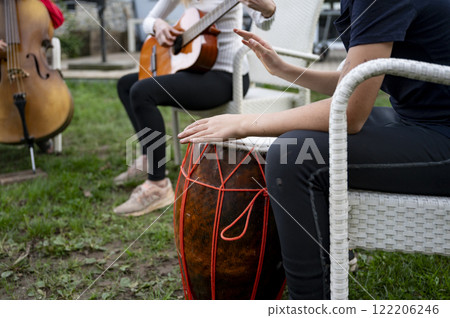 Musicians creating harmony in an outdoor jam session 122206246