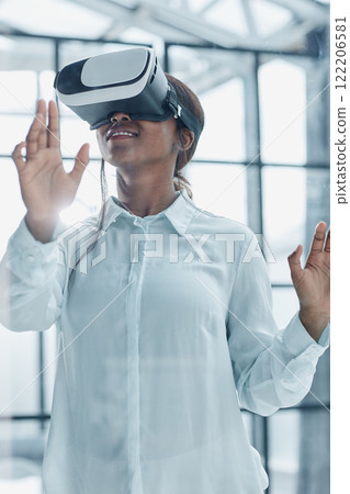 Businesswoman using vr glasses to view educational material and financial documents Businesswoman using vr glasses to view educational material and financial documents 122206581