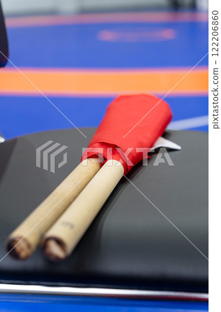 The referee's red and white flags are waiting for the referee on the chairs. 122206860