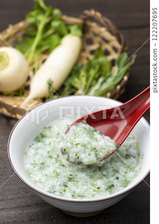 Rice porridge with seven herbs scooped up with a red spoon Rice porridge with seven herbs scooped up with a red spoon 122207695