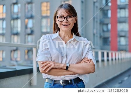 Portrait of middle-aged confident woman posing outdoors 122208056