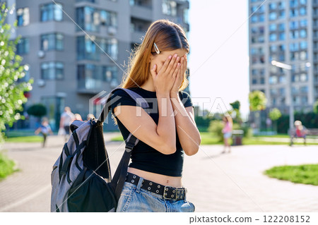 Sad unhappy teenage college student girl with backpack, outdoor, city background Sad unhappy teenage college student girl with backpack, outdoor, city background 122208152