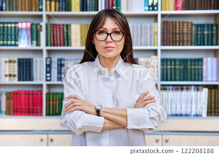 Portrait of confident elegant mature business woman in library 122208188