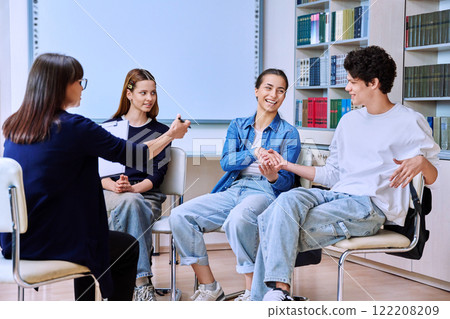 Group mental therapy, teenagers students talking with female psychologist, school counselor 122208209