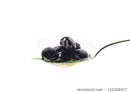 black olives in a spoon isolated on a white background black olives in a spoon isolated on a white background 122208457