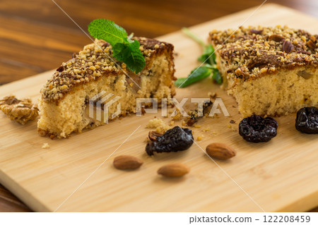 Aromatic dessert of prunes and nuts on the table Aromatic dessert of prunes and nuts on the table 122208459