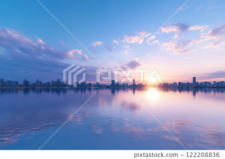 Sunset in the lake with reflection of buildings in the water. 122208836