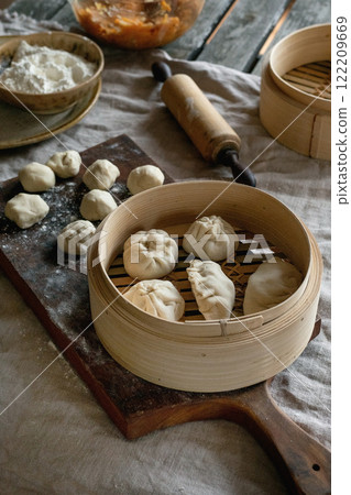 Making Asian steamed dumplings Making Asian steamed dumplings 122209669