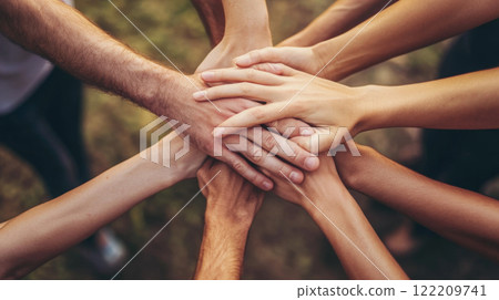 Teamwork and Unity: Hands Stacked Together 122209741