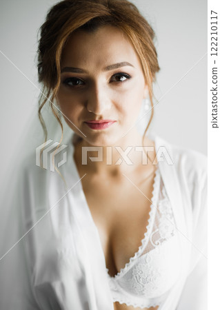 Portrait of beautiful bride with fashion veil at wedding morning Portrait of beautiful bride with fashion veil at wedding morning 122210117