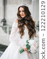 Portrait of stunning bride with long hair posing with great bouquet 122210129