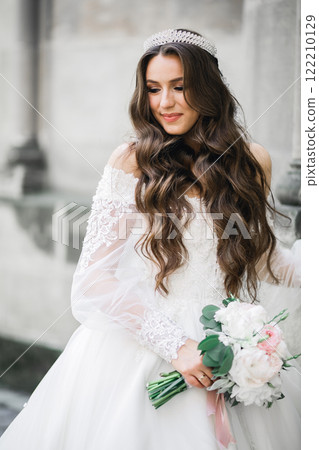 Portrait of stunning bride with long hair posing with great bouquet 122210129