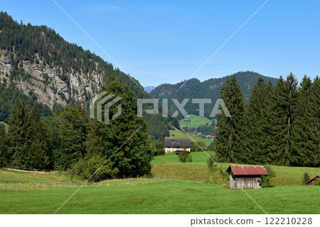 Rustic Wooden Cottage in Alpine Meadows: A Summer Retreat Amidst Majestic Mountains and Clear Blue Skies 122210228
