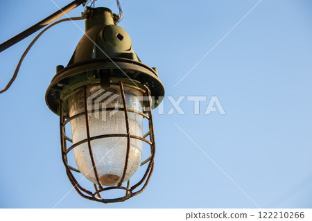 Vintage retro street lamp on a blue sky background. Vintage retro street lamp on a blue sky background. 122210266