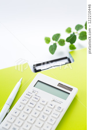 Green binder and white calculator Green binder and white calculator 122210446