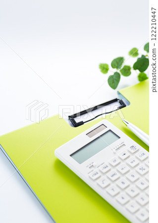 Green binder and white calculator Green binder and white calculator 122210447