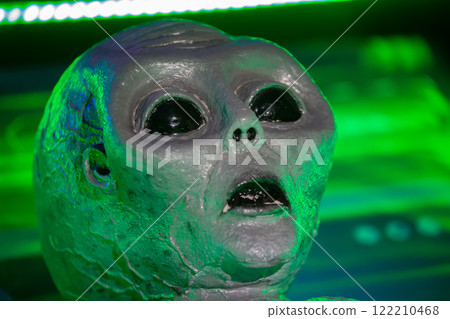 February 23, 2024. Belarus. Minsk. Educational open event about alien worlds.The alien's face is highlighted in the green color of the laboratory. The alien is a humanoid. 122210468