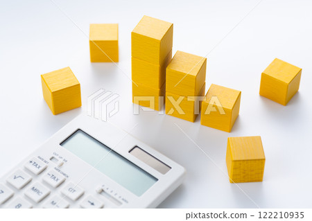 Graph made of yellow building blocks and a calculator 122210935