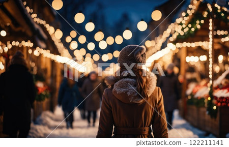 Girl walking in Christmas market decorated with holiday lights in the evening. Feeling happy in big city. Spending winter vacations in festive town. Back view. Winter holidays. AI 122211141
