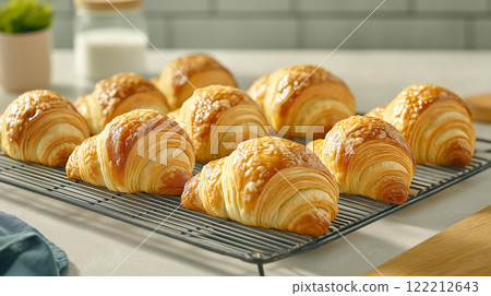 Freshly baked croissants on cooling rack, golden and flaky Freshly baked croissants on cooling rack, golden and flaky 122212643