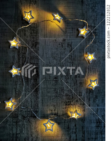 Twinkling star string lights on a dark wooden surface creating a cozy atmosphere for evening gatherings, copy space Twinkling star string lights on a dark wooden surface creating a cozy atmosphere for evening gatherings, copy space 122212812