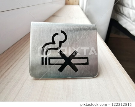 No smoking sign displayed on a metal surface, encouraging smoke-free environments for public health, close up view No smoking sign displayed on a metal surface, encouraging smoke-free environments for public health, close up view 122212815