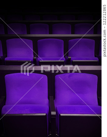 Purple seats floating in a movie theater spotlight Purple seats floating in a movie theater spotlight 122212865