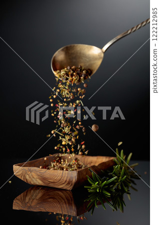 Fresh rosemary and dried spices on a black background. Fresh rosemary and dried spices on a black background. 122212985