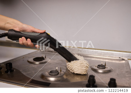 Performing a Deep Cleaning of Kitchen Equipment Using a Steam Cleaner for Hygiene and Safety 122214419