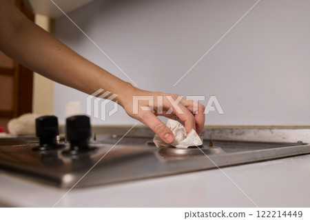 Cleaning a gas stove burner with careful precision is an essential part of kitchen maintenance 122214449
