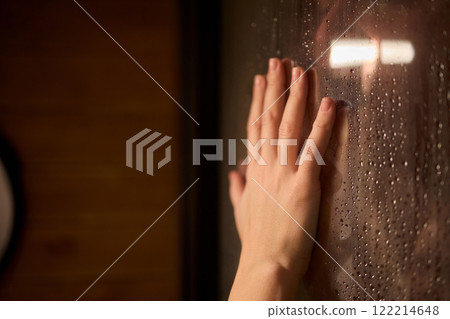 Hand Placed Against Glass in a Rainy and Melancholic Atmosphere, Evoking Deep Emotions Hand Placed Against Glass in a Rainy and Melancholic Atmosphere, Evoking Deep Emotions 122214648