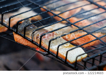 Delightful grilled trout fish infused with smoky flavors perfect for a summer gathering under the sun 122214683