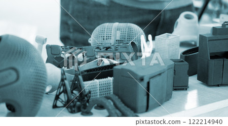 Various objects printed on 3D printer from molten plastic powder. Different models printed on 3D printer from melted black grey polyamide powder. Additive 3D printing Multi Jet Fusion MJF technology 122214940