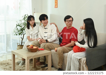 Happy family sharing laughter and stories on the sofa during Chinese New Year celebration 122215175