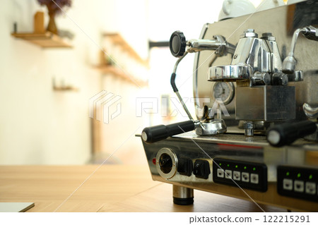 Close up of an espresso machine on a wooden counter in a minimalist cafe 122215291