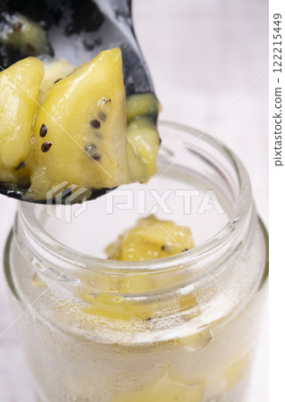 Freshly made kiwi jam packed into glass jars 122215449