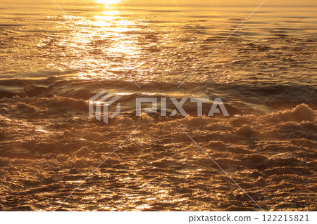 Spring rural morning scenery: A flowing river shining in the morning sun Spring rural morning scenery: A flowing river shining in the morning sun 122215821