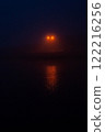 Night seaport. Light of lanterns reflects in water. Mystical place 122216256