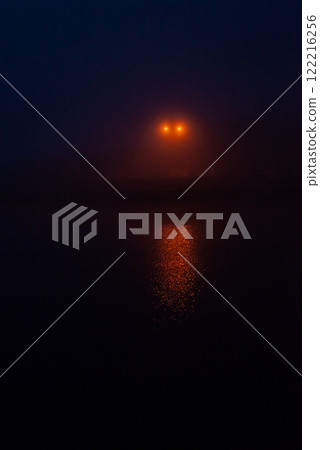 Night seaport. Light of lanterns reflects in water. Mystical place 122216256