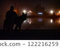 A man with a dog on a sea pier late at night 122216259