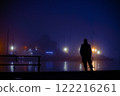 Man at night in a seaport. Foggy mystical place 122216261