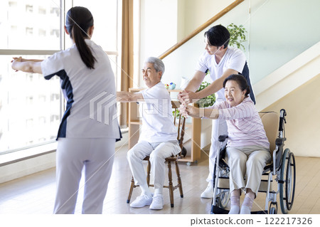 Caregiver: Seniors stretching with a physical therapist 122217326