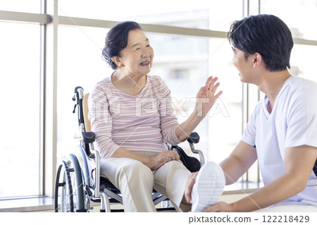 Medical: Senior woman receiving a medical examination from a physical therapist 122218429