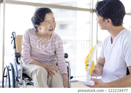 Medical: Senior woman receiving a medical examination from a physical therapist 122218477
