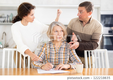 Old woman signing papers Old woman signing papers 122218635