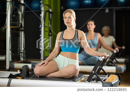 Portrait of a blonde woman on a reformer Portrait of a blonde woman on a reformer 122218691