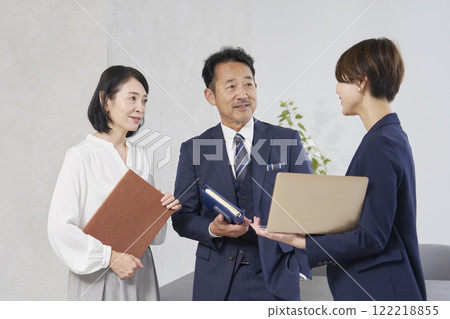 Businesswoman and businessman talking in the office Businesswoman and businessman talking in the office 122218855