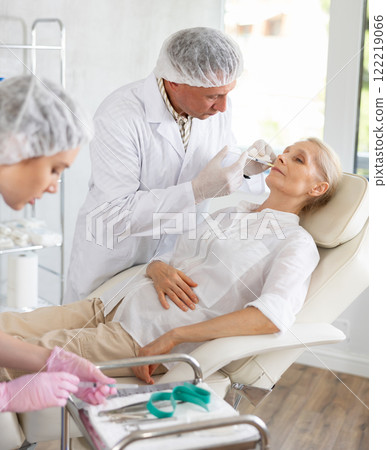 Woman applying rejuvenating treatments by doctor. 122219066